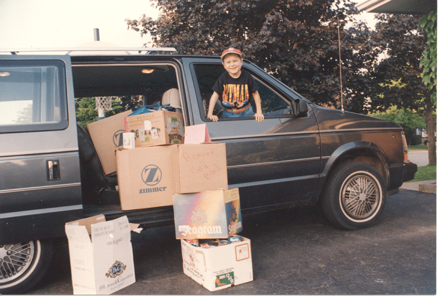 boy in van surrounded by boxes